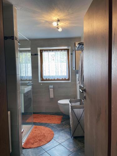 a small bathroom with a toilet and a window at Ferienwohnung Schildwolf in Fieberbrunn