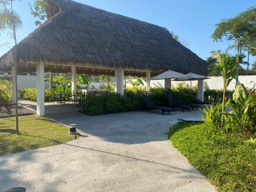 a pavilion with chairs and tables and umbrellas at Beautiful Family Beach House Nuevo Vallarta in Naranjo