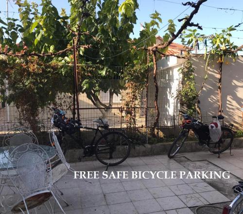 a bike parked next to a bicycle parked next to a fence at Ion Apartments Messolonghi Double Room Sea View Loft in Mesolongion