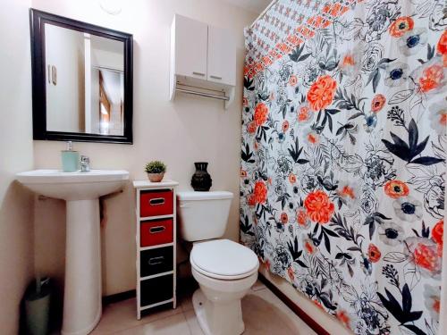 a bathroom with a toilet and a sink at Cabañas altos de Mirasol in Puerto Montt