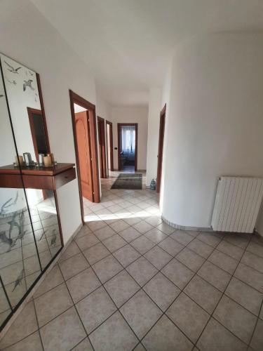 a hallway with white walls and a tile floor at Casa Bellavista in Neive
