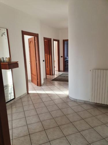 a hallway with many doors and a tile floor at Casa Bellavista in Neive