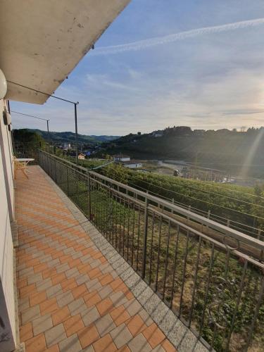 a view from the balcony of a house with a fence at Casa Bellavista in Neive