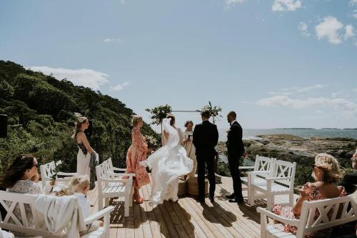 a wedding ceremony on a deck with a bride and groom at Langesund Bad in Langesund
