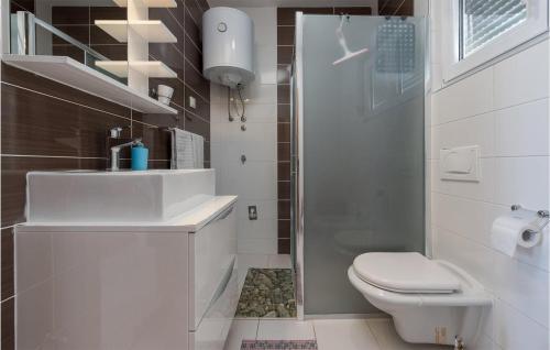 a bathroom with a toilet and a sink and a shower at 1 Bedroom Nice Apartment In Vir in Vir