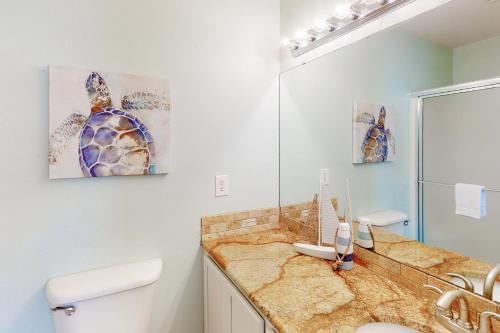 een badkamer met een wastafel en een spiegel bij Flamingo Lagoon in Corpus Christi