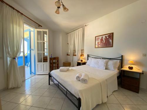 a bedroom with a large bed with two towels on it at Pantazis Studios in Agios Nikitas in Agios Nikitas
