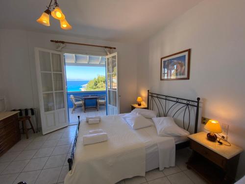 a bedroom with a bed and a view of the ocean at Pantazis Studios in Agios Nikitas in Agios Nikitas