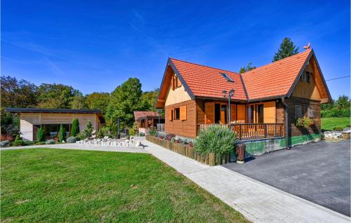 a wooden house with a red roof at Holiday Home Gradec in Brežane Lekeničke