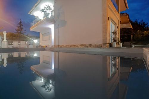 a house with a swimming pool at night at Gold Coast Photography Inn in Estoril