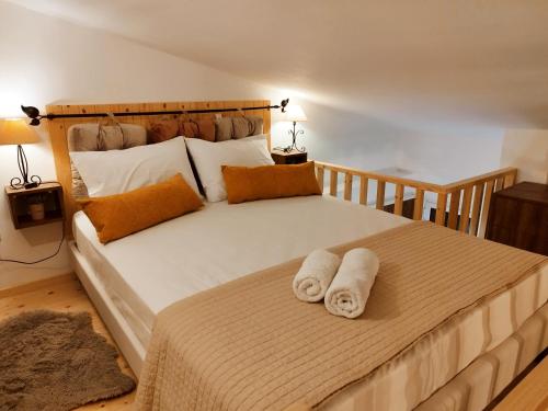 a bedroom with a large bed with towels on it at Luxury Loft Apartment Vivian in Patra