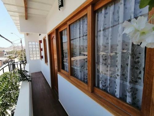 a balcony of a house with windows at ApartamentoAQUA in Los Órganos