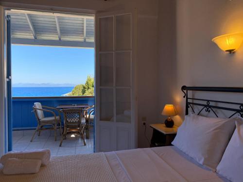 a bedroom with a bed and a view of the ocean at Pantazis Studios in Agios Nikitas in Agios Nikitas