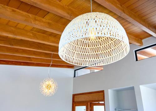 a large white chandelier hanging from a wooden ceiling at Valle Soléa in El Porvenir