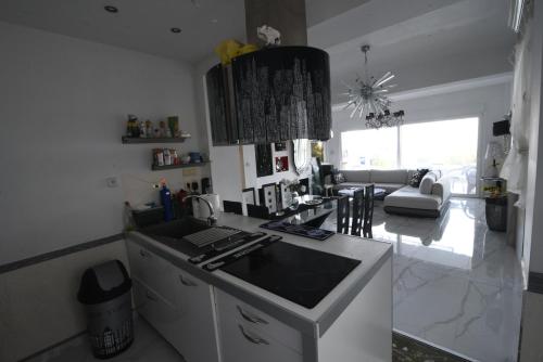 a kitchen with a counter and a living room at Villa Panorama, now a Smart Home in Skala Kallirakhis
