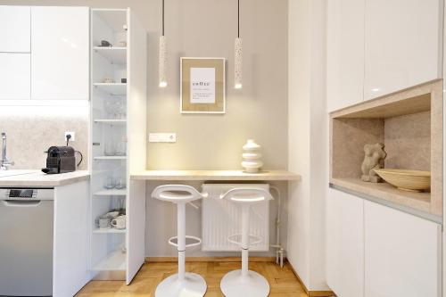 a kitchen with a counter with stools in it at Athens Delight Apartment in Pagrati in Athens