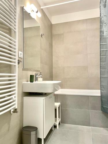 a bathroom with a sink and a bath tub at Top in Bratislava