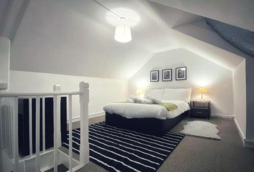 a bedroom with a bed in a attic at Urban Music Style Townhouse in Swansea city center in Swansea