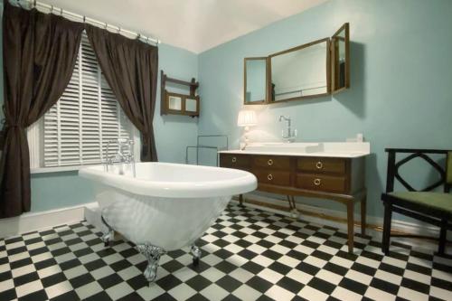 a bathroom with a large tub and a sink at Urban Music Style Townhouse in Swansea city center in Swansea