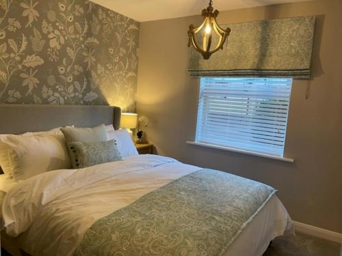 a bedroom with a large bed and a window at Pedlars Rest in Swaffham