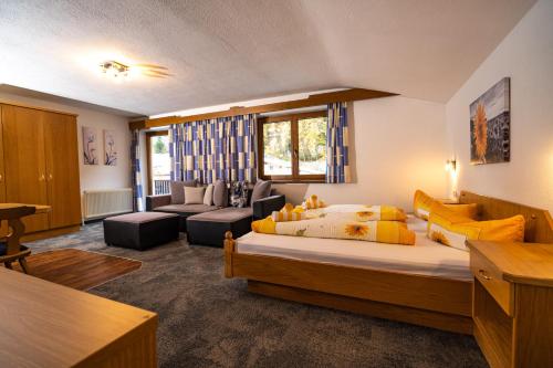 a bedroom with a bed and a living room at Haus Anton Sölden - Apartments & Zimmer in Sölden