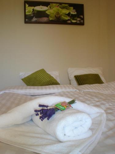 a towel laying on top of a bed at Apartamenty Lawenda in Rabka