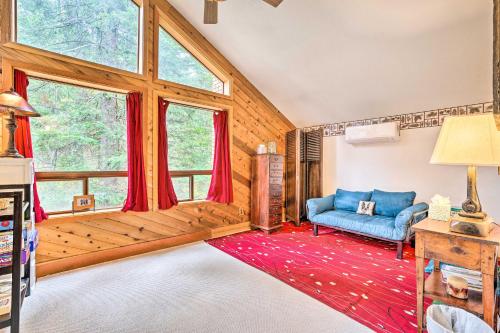 a living room with a blue couch and a large window at Wenatchee Retreat with Deck Less Than 4 Mi to Skiing! in Wenatchee