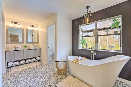 a large bathroom with a tub and a window at Luxury Maineville Villa with Private Pool and Deck in Maineville