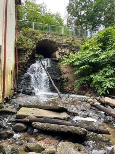 a stream of water flowing out of a tunnel at Krioklio Namelis Verkiuose in Vilnius