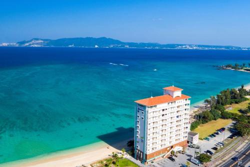 an aerial view of a building next to the ocean at Best Western Okinawa Kouki Beach in Nago