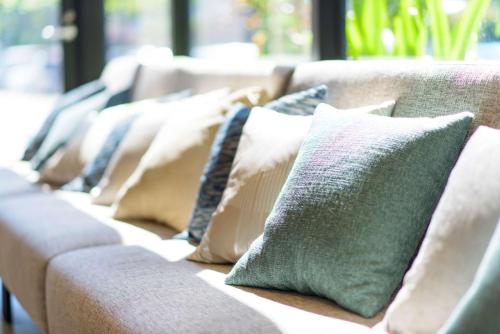 a row of pillows sitting on a couch at Best Western Okinawa Kouki Beach in Nago