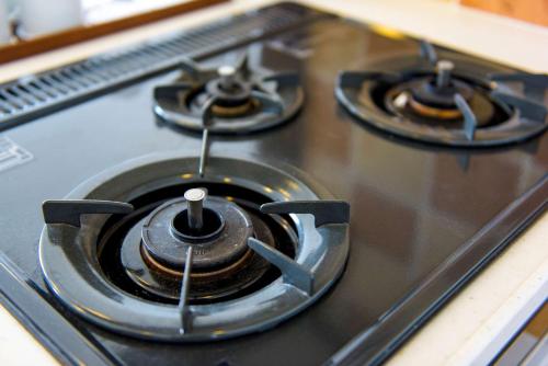 a stove top with three burners on it at Best Western Okinawa Kouki Beach in Nago