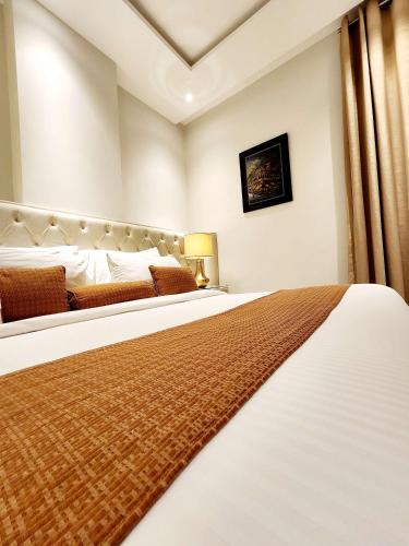 a bedroom with two beds in a room at Best Western Premier Hotel Gulberg Lahore in Lahore