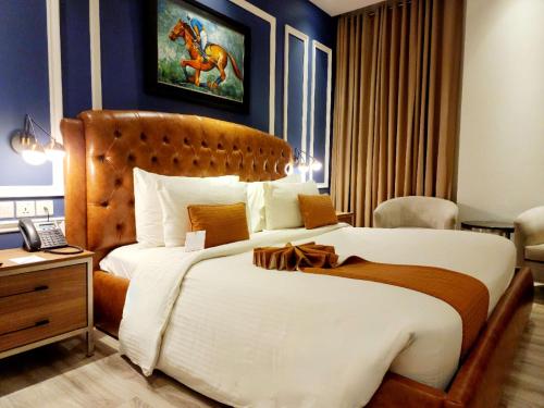 a bedroom with a large bed with a horse on the wall at Best Western Premier Hotel Gulberg Lahore in Lahore