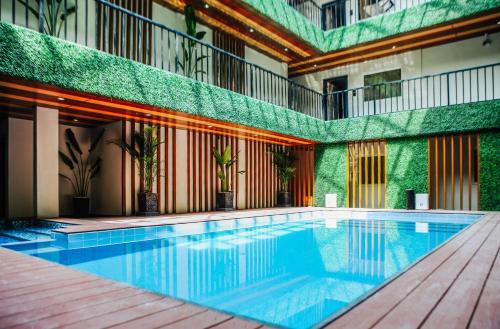 a swimming pool in the middle of a building at SureStay Studio by Best Western Clarkview Angeles City in Angeles