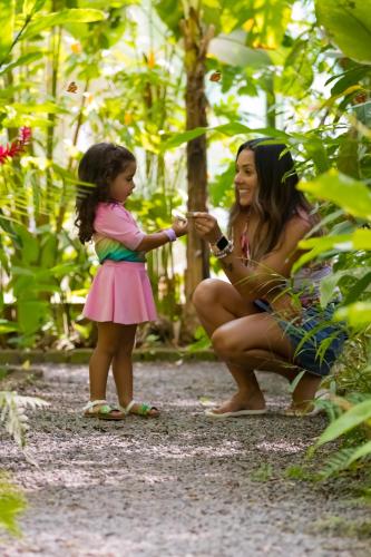a woman and a little girl in a forest at Hotel Punta Leona in Jacó