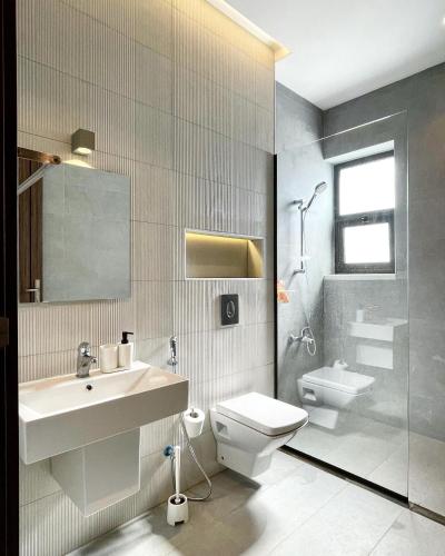 a bathroom with a sink and a toilet and a shower at Stay Chalet Deadsea in Ash Shāghūr