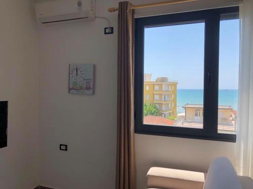 a room with a window with a view of the ocean at Sea View Deluxe Apartment in Durrës