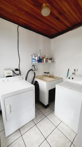 a bathroom with a sink and two sinks and a counter at Don Carlos Place in Alajuela