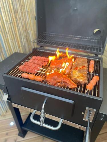 a grill with meat and other foods on it at NEW PROCHE NAUSICAA ! « Mille et Un Rêve » in Boulogne-sur-Mer