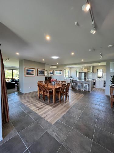 a dining room and kitchen with a table and chairs at Manakau Lodge in Kaikoura