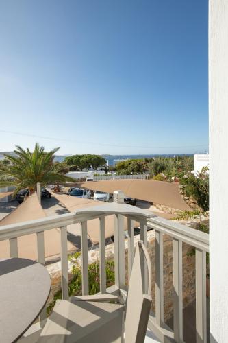 a balcony with chairs and a view of the beach at Fabrikas in Mýkonos City