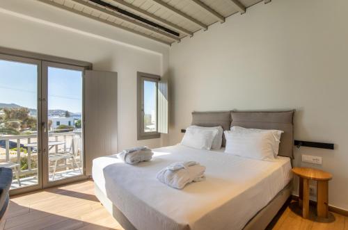 a bedroom with a large bed with two towels on it at Fabrikas in Mýkonos City