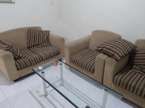 2 sillas y mesa de centro en una habitación en WisPing, en Tanjung Pinang