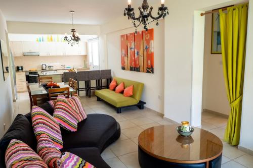 a living room with a couch and a table at Stylish 2 Bedroom apartment in Pegia in Peyia