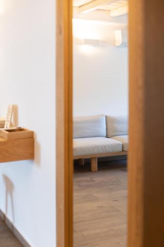 a living room with a couch and a mirror at Fabrikas in Mýkonos City