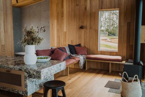a living room with a couch and a window at Upland Farm Luxury Cabins, Denmark Western Australia in Denmark