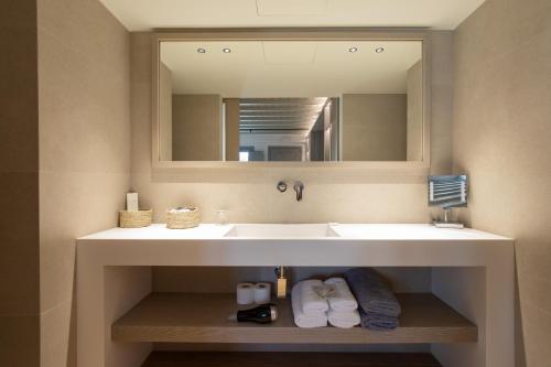 a bathroom with a white sink and a mirror at Fabrikas in Mýkonos City