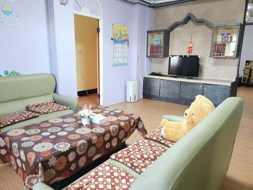 a teddy bear sitting on a table in a room at Bokelai B&B in Renai