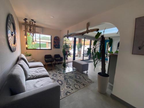a living room with a couch and a table at Berlor Airport Inn in Alajuela City